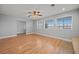 Living room featuring wood floors, large windows, and a ceiling fan at 2925 Rice St, Logandale, NV 89021