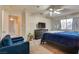 Spacious bedroom with blue bedding and a sitting area at 3258 Epson St, Las Vegas, NV 89129