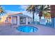 Community hot tub or spa area with palm trees and safety fence at 4889 S Torrey Pines Dr # 105, Las Vegas, NV 89103