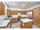 Kitchen with light wood cabinets, stainless steel appliances, and an island at 5327 Caprock Canyon Ave, Las Vegas, NV 89139