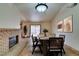 Bright dining area with a brick fireplace and a six-person table at 6105 Heather Mist Ln, Las Vegas, NV 89108