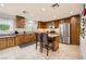 Kitchen with wooden cabinets, stainless steel appliances, and island at 689 Iron Bridge St, Las Vegas, NV 89178