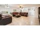 Living room with leather sofas, tiled floor, and access to kitchen at 689 Iron Bridge St, Las Vegas, NV 89178