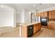 Kitchen boasts an island, stainless steel appliances, and wood cabinetry at 7119 Wolf Rivers Ave, Las Vegas, NV 89131