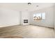 Living room with corner fireplace and hardwood floors at 7119 Wolf Rivers Ave, Las Vegas, NV 89131