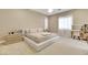 Well-lit bedroom with a queen bed and vanity area at 7590 Sky Horse Ave, Las Vegas, NV 89113