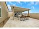 Covered patio with outdoor kitchen and bar seating at 7590 Sky Horse Ave, Las Vegas, NV 89113