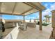 Outdoor kitchen and dining area with pool view at 7590 Sky Horse Ave, Las Vegas, NV 89113