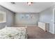 Bright bedroom featuring three windows and a dresser at 8216 Valley Stream Ave, Las Vegas, NV 89131