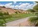 View of a golf course with houses on a hillside and a pond at 1004 Crest View Dr, Mesquite, NV 89027