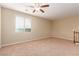 Spacious bedroom with large window, ceiling fan, and neutral decor at 1172 Via Della Costrella, Henderson, NV 89011