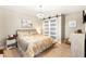 Spacious bedroom with large bed, barn door, and light flooring at 1195 Calcione Dr, Henderson, NV 89011