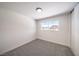 Spacious bedroom with grey carpet and a window with solar panels view at 2512 Capistrano Ave, Las Vegas, NV 89121