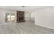 Living room with stone fireplace, sliding glass doors to patio, and gray flooring at 3115 La Mesa Dr, Henderson, NV 89014