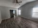 Main bedroom with high ceiling, mirrored closet, and wood-look flooring at 416 Bel Air Ave, Pahrump, NV 89048