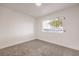 Bright bedroom with gray carpet and large window at 428 Rossmoyne Ave, North Las Vegas, NV 89030