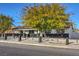 Charming curb appeal with teal front door, black accents, and a well maintained lawn at 428 Rossmoyne Ave, North Las Vegas, NV 89030