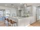 Renovated kitchen featuring a white corner island and stainless steel appliances at 428 Rossmoyne Ave, North Las Vegas, NV 89030