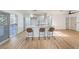 Modern kitchen island with seating, white cabinets and stainless steel appliances at 428 Rossmoyne Ave, North Las Vegas, NV 89030