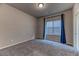 Bright bedroom featuring carpet flooring and a window with curtains at 4532 Pointleaf St, North Las Vegas, NV 89032