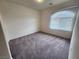 Bright bedroom featuring neutral walls and carpet, plus a window with blinds at 6017 Gordon Creek Ave, Las Vegas, NV 89139