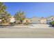 Single-story house with a two-car garage and desert landscaping at 6020 Theatrical Rd, North Las Vegas, NV 89031