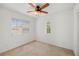 Bedroom with ceiling fan, large window, and neutral decor at 7454 Pember St, Las Vegas, NV 89143