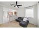 Open-concept living room with kitchen view and gray sectional sofa at 7454 Pember St, Las Vegas, NV 89143