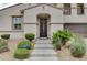 Attractive front door entry with landscaping and stone pathway at 897 Las Palomas Dr, Las Vegas, NV 89138