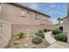 Landscaped pathway with decorative plants and a stone statue at 897 Las Palomas Dr, Las Vegas, NV 89138