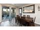 Bright dining room features a wood table with blue chairs, and sliding glass doors to backyard at 909 Riverlawn Pl, Las Vegas, NV 89138