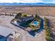 Aerial view showing house, pool, and surrounding landscape at 9350 Homestead Rd, Las Vegas, NV 89143