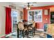 Cozy dining area with red wall and access to outdoor deck at 9350 Homestead Rd, Las Vegas, NV 89143