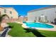 Inviting kidney shaped pool with grassy backyard at 9675 Flying Eagle Ln, Las Vegas, NV 89123