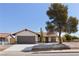 Single story home with brown garage door and mature tree in front at 110 Palo Verde Dr, Henderson, NV 89015