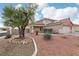 Two-story house with a three-car garage and mature tree at 1111 Healing Waters Ln, North Las Vegas, NV 89031