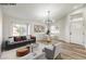 Virtually staged living room with dining area and hardwood floors at 1941 Toscanini Way, North Las Vegas, NV 89032