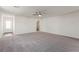 Open living room with gray carpeting and access to the front door at 2617 Freya Valley St, Las Vegas, NV 89156