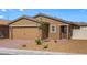 Single-story house with a two-car garage and desert landscaping at 2623 Freya Valley St, Las Vegas, NV 89156