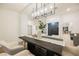 Elegant dining room with a statement chandelier and views to the living room at 4016 Tyler William Ln, Las Vegas, NV 89130