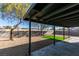 Backyard with covered patio, artificial grass, and gravel at 459 Ash St, Henderson, NV 89015