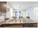 Kitchen with granite countertops, double sink, and view into dining area at 4626 Lime Straight Dr, Las Vegas, NV 89115