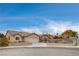 Single story house with a two-car garage and a landscaped yard at 5217 Yellow Dawn Ct, Las Vegas, NV 89130