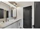 Modern bathroom with double vanity, white cabinets, and tile at 62 Incline Village Ct, Henderson, NV 89074