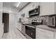 Bright kitchen with white cabinets, stainless steel appliances, and gray countertops at 730 S Royal Crest Cir # 421, Las Vegas, NV 89169