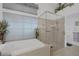 Bathroom featuring a large shower, a spacious tub, and elegant fixtures at 808 Hillgrove Ct, Las Vegas, NV 89145