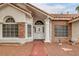 Brick and stucco exterior with a white door and arched windows at 808 Hillgrove Ct, Las Vegas, NV 89145