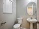 Clean bathroom with pedestal sink and updated toilet at 954 Ashford Hollow Ave, Henderson, NV 89012