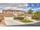 Two-story house with beige exterior, two-car garage, and landscaping at 11368 Rancho Portena Ave, Las Vegas, NV 89138