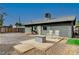 Backyard view of home with rocking chairs and fire pit at 207 W Victory Rd, Henderson, NV 89015